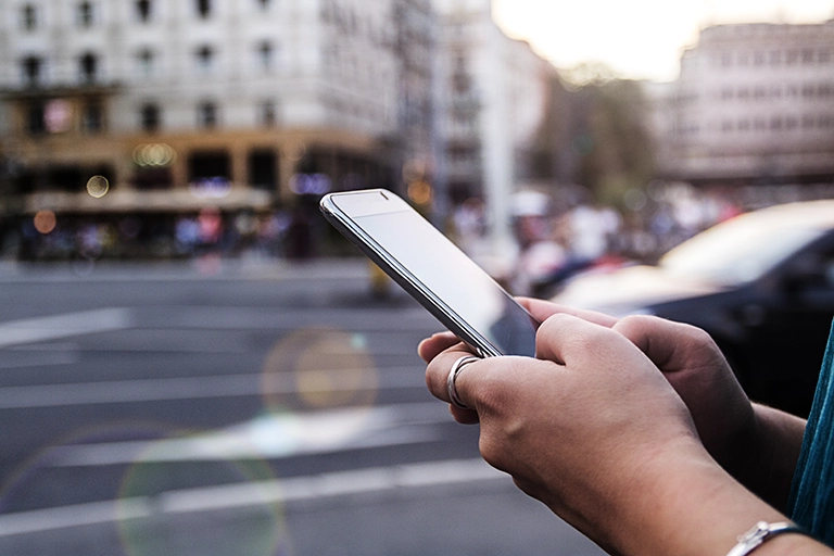 Person using phone in city